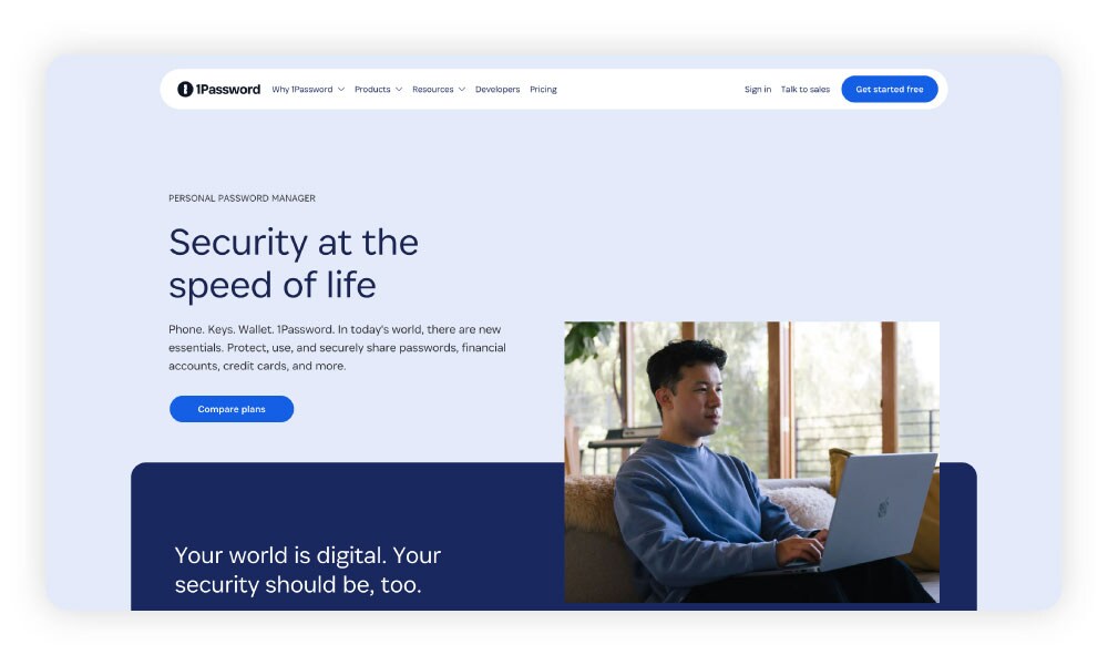 Screenshot of 1Password Families homepage featuring a man using a password manager on his laptop.