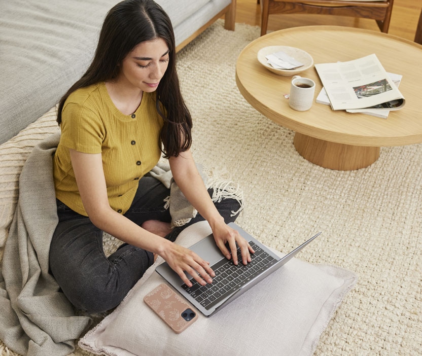 Woman looking at her laptop reading about the dangers of fake antivirus software.