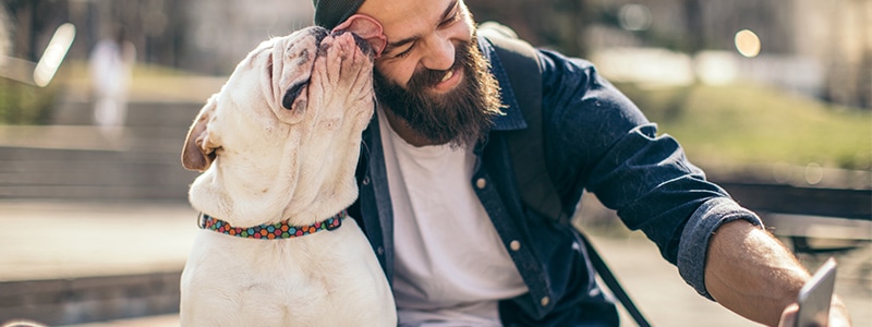 A man and his dog taking a selfie with a secure Android phone.