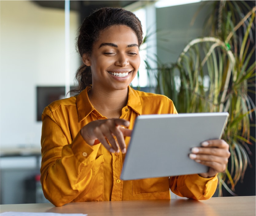 A woman reads about encryption on her tablet, answering the question, "What is encryption?"