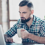 A person using a laptop to access the internet securely with a VPN.