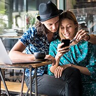 Couple looking on device to see if their names were part of a privacy breach