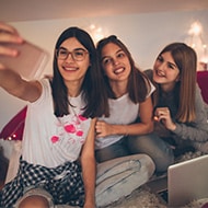 Three teenage girls taking a selfie - highlighting a potential risk for parents with teenagers and needing to know about online safety tips.