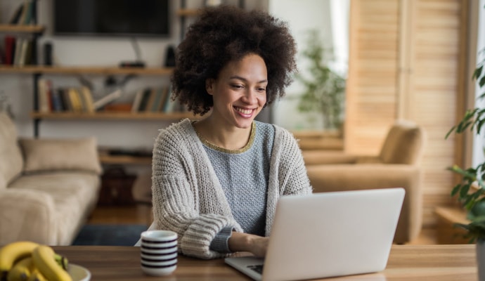 Girl shopping for Norton AntiVirus Plus on a laptop.