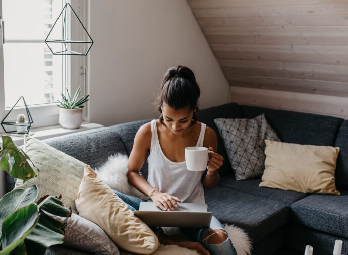 Man relaxing on couch using his laptop